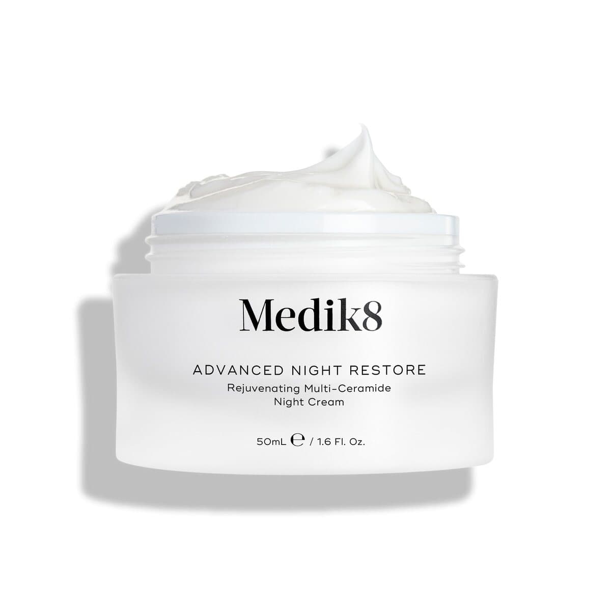 An open white jar of Medik8 Advanced Night Restore night cream.