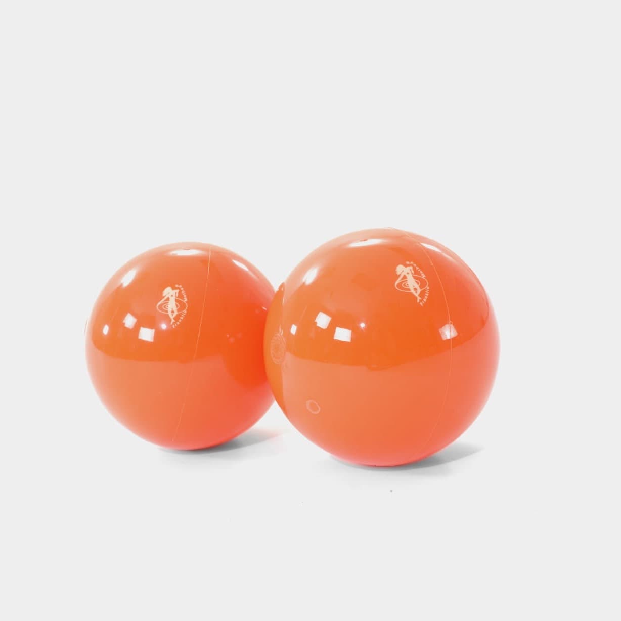 Two glossy orange Franklin Smooth Balls resting together on a pale grey ground.